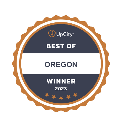 A circular badge with an orange scalloped edge and dark blue center reads UpCity Best of Oregon Winner 2023 with five orange stars at the bottom.